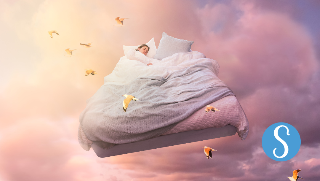 A lady sleeping on a bed in the clouds surrounded by birds