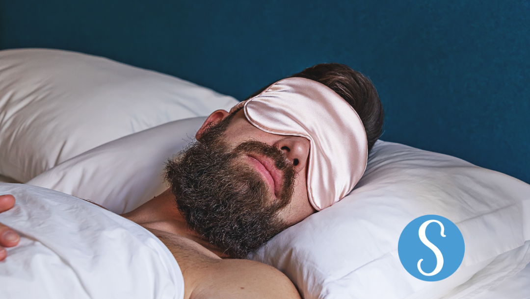 A man is sleeping with a sleep mask on — SnoreLessNow