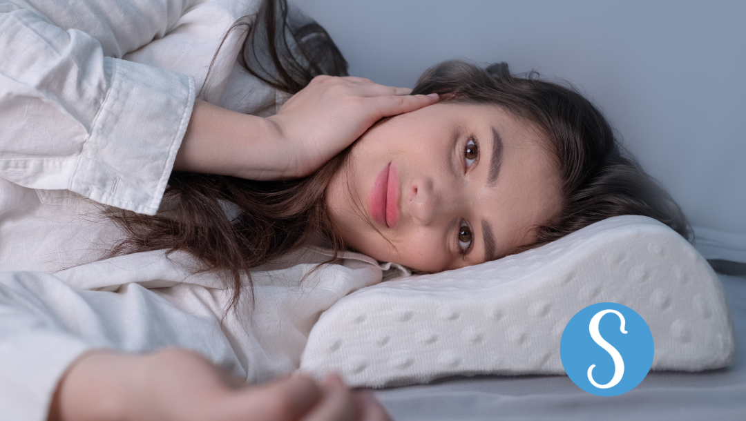 A woman sleeping on an anti-snoring pillow.