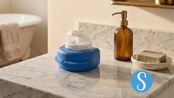 A Somnofit-S anti-snoring mouth guard sits on a bathroom vanity. 