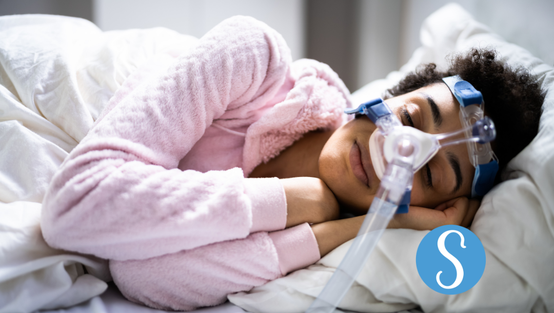 A woman sleeping with a CPAP machine - SnoreLessNow