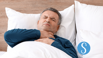 A man lying in bed with a sore throat