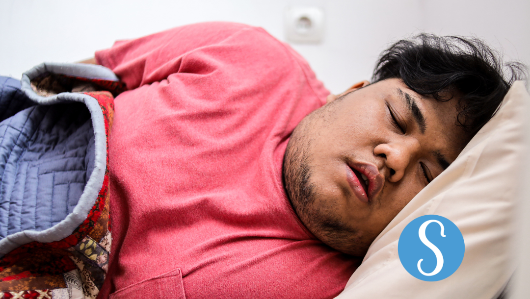 An overweight man sleeping