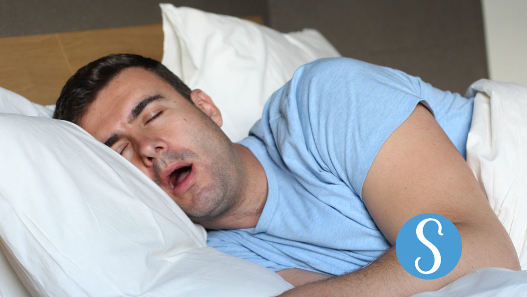 A man snoring with his mouth wide open
